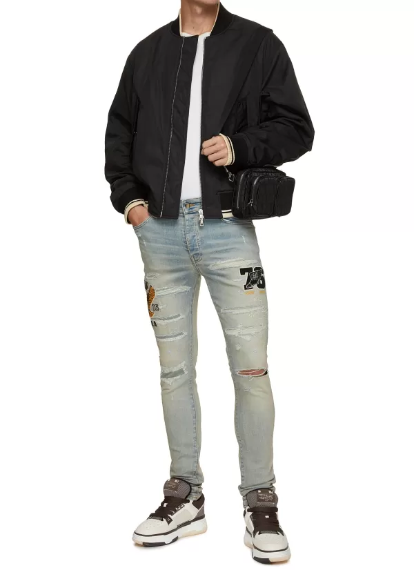 Pants>AMIRI Varsity Eagle Logo Distressed Skinny Jeans